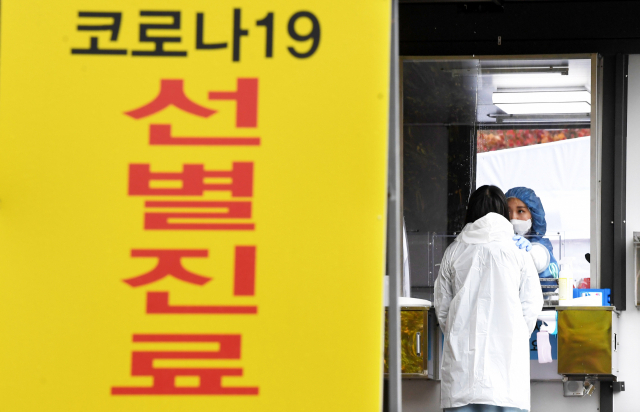 19일 오후 창원시 진해보건소 코로나19 선별진료소에서 의료진이 한 내원객의 검채를 채취하고 있다./김승권 기자/