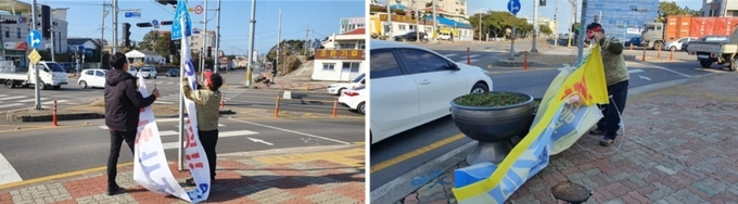 제주 제2공항 여론조사가 마무리되자 서귀포시 성산읍 직원들이 제2공항 찬반 현수막을 제거하고 있다.