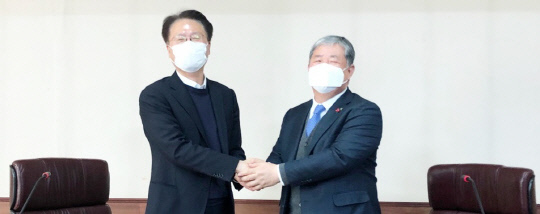 최상권(왼쪽) 신우산업 회장과 정태희 삼진정밀 대표가 5일 대전상공회의소에서 정 대표로의 대전상의 회장 후보 단일화 결정을 발표한 뒤 악수하고 있다. 사진=문승현 기자