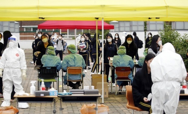 지난 22일 오후 광주 북구 한 고등학교에 설치된 임시 선별진료소에서 학생들이 코로나19 검사를 받고 있다.<북구청 제공>