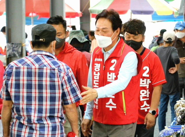 국민의힘 박완수 경남도지사 후보가 19일 김해시 진영읍 진영전통시장을 방문해 유권자들에게 인사를 하고 있다./전강용 기자/